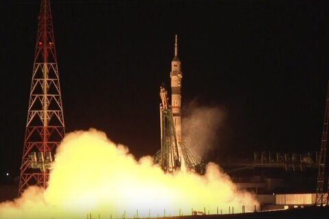 A Soyuz craft with 2 Russians and 1 American docks at the International Space Station