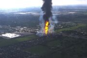 A pipeline explosion sends a towering pillar of flame over Houston's suburbs