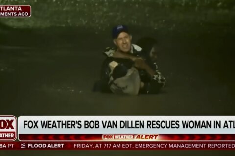 A TV reporter was doing a live hurricane report when he rescued a woman from a submerged car