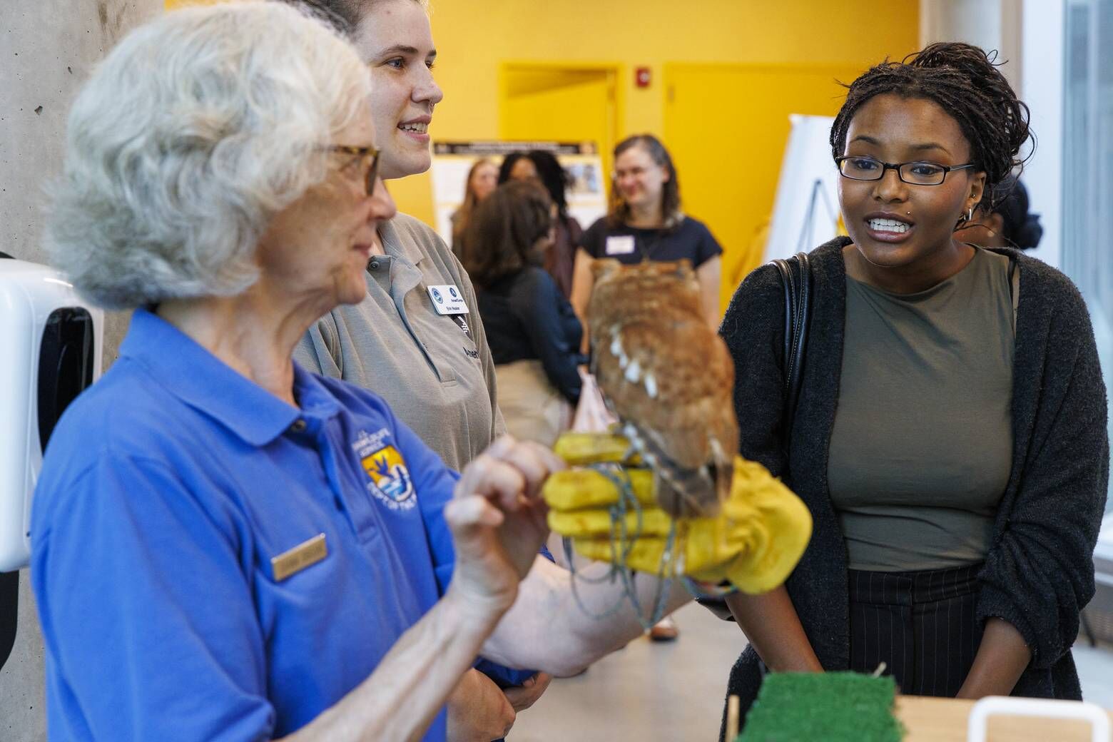 Students interact with Red, an 18-year-old screech owl, during an MOU signing with the U.S. Fish and Wildlife Service between Bowie State University, Alabama A&M and Bethune-Cookman University, Friday, Sept. 27, 2024. (Courtesy Bowie State University)