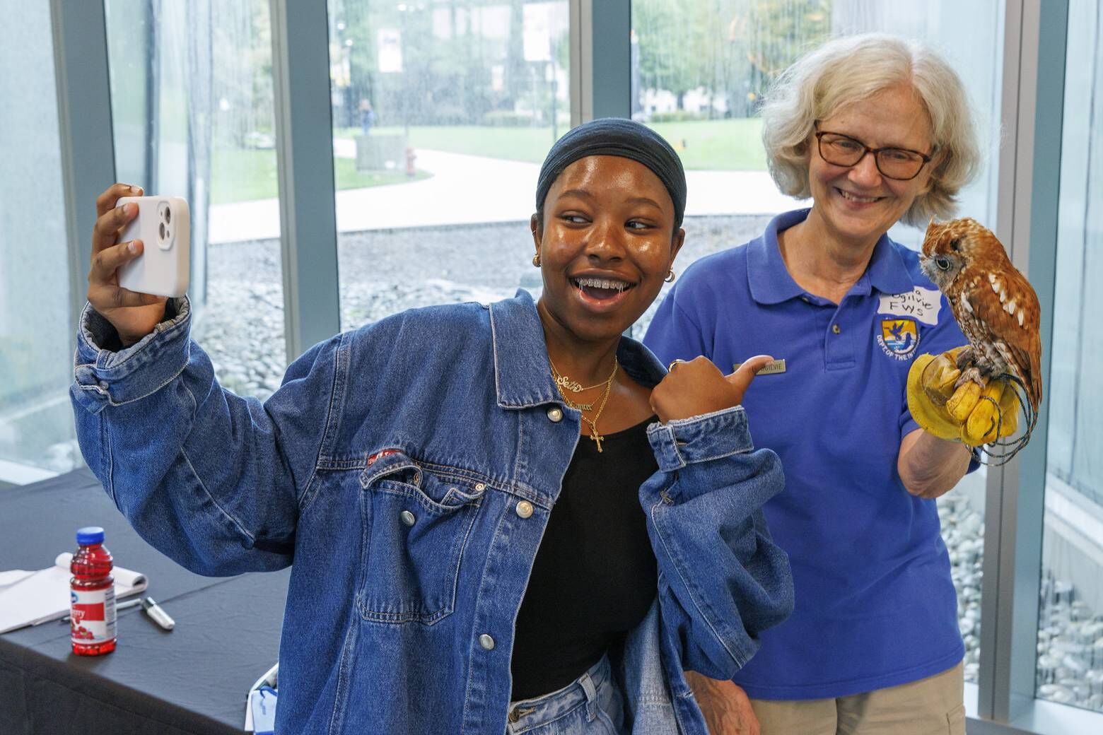 Students interact with Red, an 18-year-old screech owl, during an MOU signing with the U.S. Fish and Wildlife Service between Bowie State University, Alabama A&M and Bethune-Cookman University, Friday, Sept. 27, 2024. (Courtesy Bowie State University)