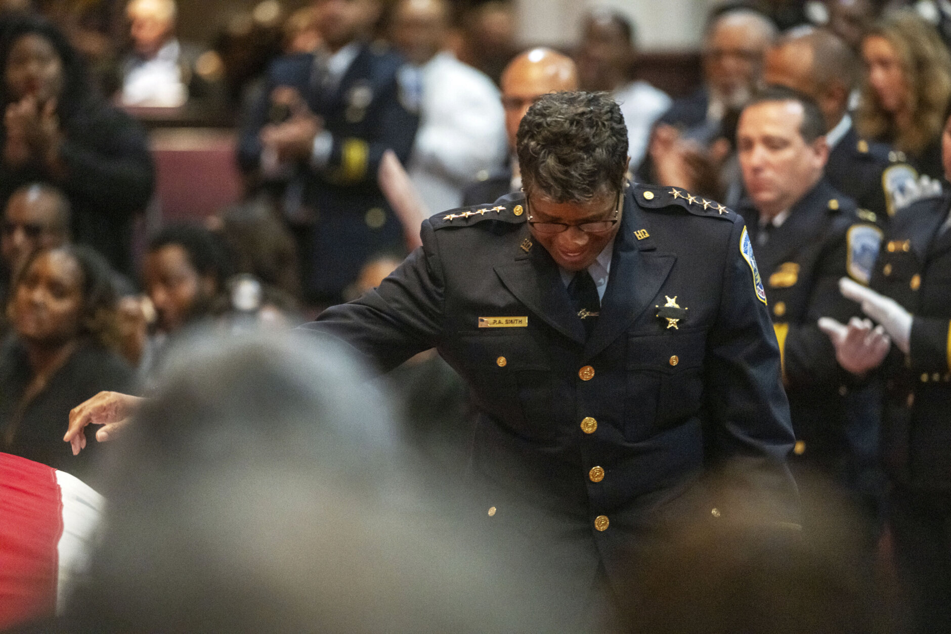 D.C. Police Chief Pamela Smith touches the casket of officer Wayne David