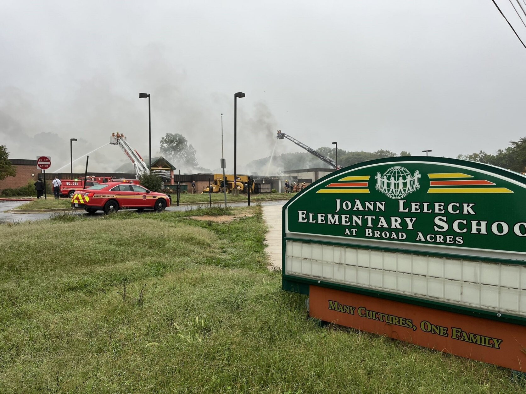 Firefighters fighting fire at closed school building.