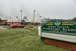 Firefighters fighting fire at closed school building.