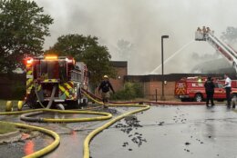 Firefighters fighting fire at closed school building.