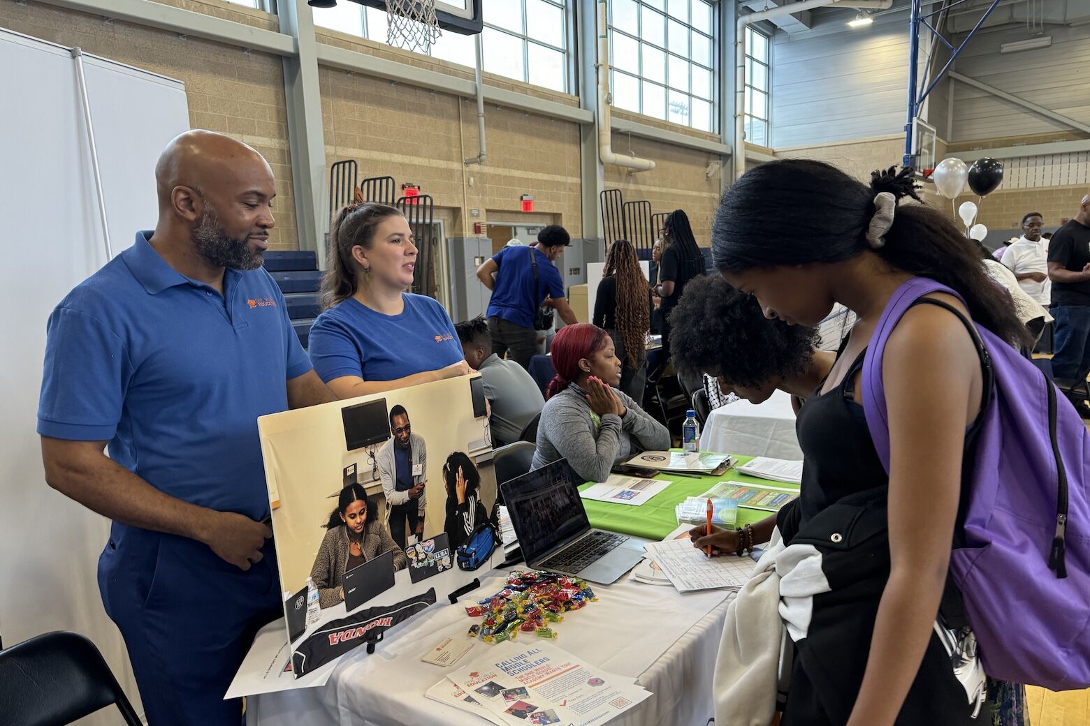 People at an after-school programs fair.