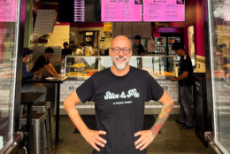 Man in front of pizza shop