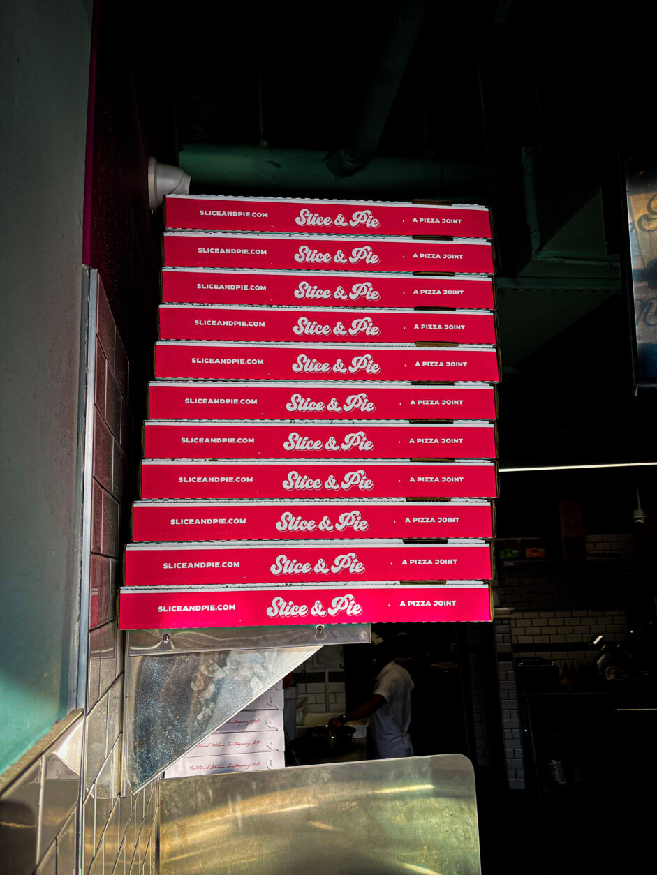 Stack of pizza boxes.