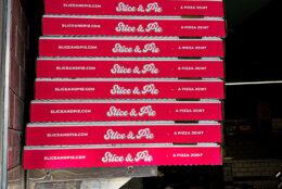 Stack of pizza boxes.