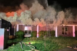 Firefighters fighting fire at closed school building.