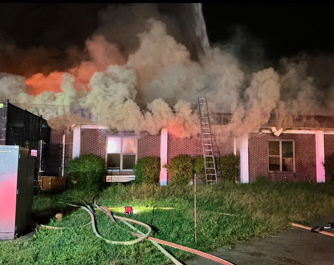 Firefighters fighting fire at closed school building.