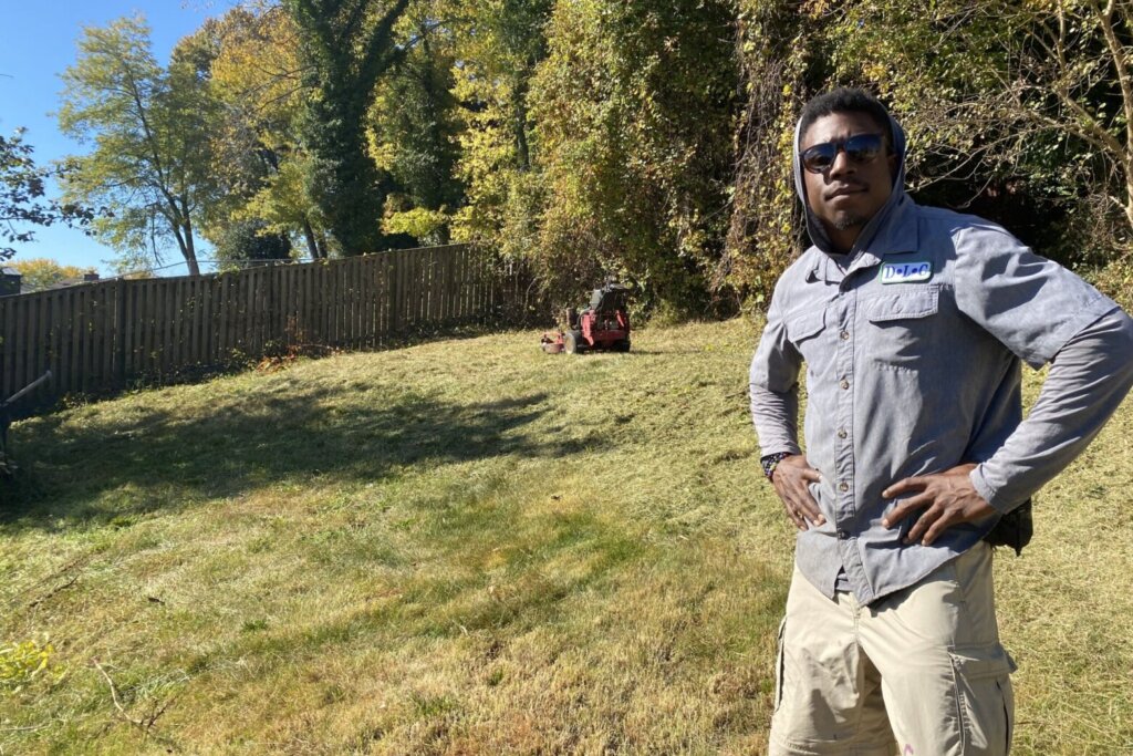 landscaper stands in yard