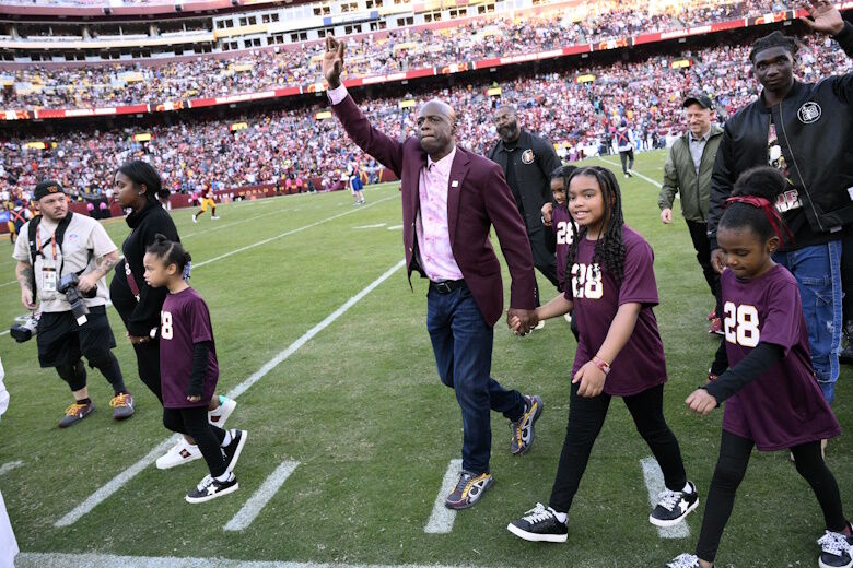 Former Washington defensive back Darrell Green reacts to fans after a jersey retirement ceremony at halftime of an NFL football game between the Washington Commanders and the Carolina Panthers, Sunday, Oct. 20, 2024, in Landover, Md. (AP Photo/Nick Wass)