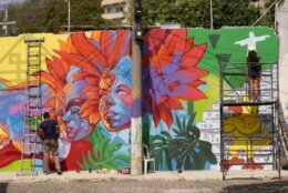 <p>In the Santo Cristo area of Rio, D.C.-based artists Gabriel Lemos, My Ly and Aniekan Udofia are working to create a D.C.-inspired mural.</p>
