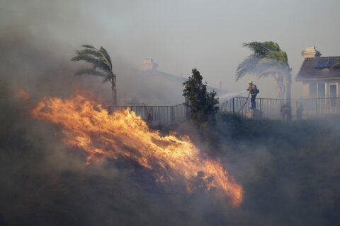 A fast-moving brush fire in California burned 2 homes while others were damaged by smoke and water