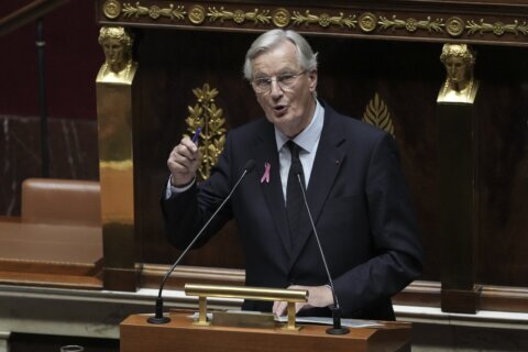 France's prime minister vows to curb debt as he faced baptism of fire at heckled parliament