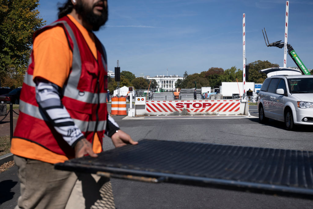 Workers install security fencing around the White House grounds in preparation for a rally with US Vice President and Democratic presidential nominee Kamala Harris on the Ellipse in Washington, DC, on October 28, 2024. (Photo by Brendan Smialowski / AFP) (Photo by BRENDAN SMIALOWSKI/AFP via Getty Images)