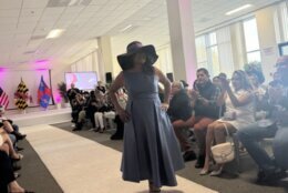 woman models hat on white carpet