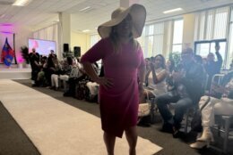 woman models hat on white carpet