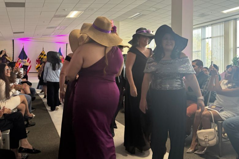 women model hats on white carpet