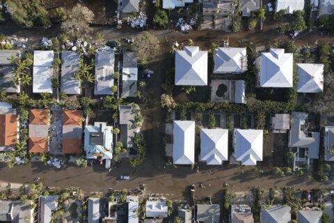 Residents slog through flooded streets, clear debris after Hurricane Milton tore through Florida