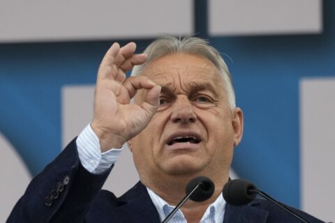 Hungary’s Orbán interrupted by activist during EU presidency news conference