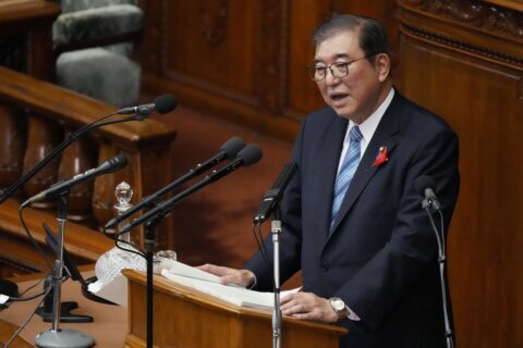 Japan’s new leader expresses regret for governing party slush fund scandal, vows stronger defense