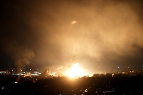 Israeli airstrikes rock southern suburbs of Beirut and cut off a key crossing into Syria