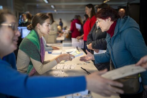 Lithuanians vote in parliamentary election with many looking for change despite a strong economy