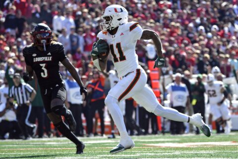 Cam Ward throws for 4 touchdowns, No. 6 Miami survives Louisville comeback bids for wild 52-45 win