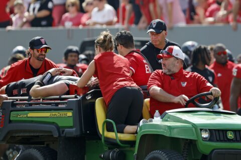 NC State QB McCall is carted off the field following a helmet-jarring hit