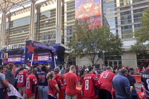 Fans watch as the Capitals walk the red carpet into their 50th season opener