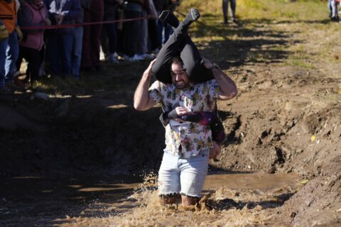 Mud, beer and cash: Annual wife-carrying championship attracts competitive couples to Maine