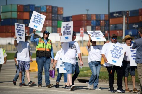 Striking port workers to return to work Friday as negotiators reach an agreement on wages