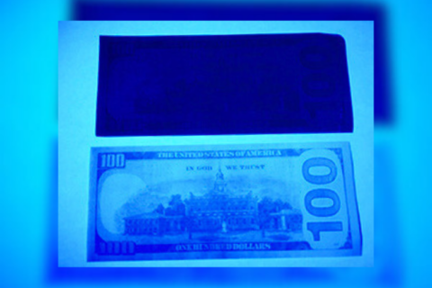 Customs: Ultraviolet light reveals the true color of fake money in an arrest at Dulles