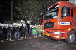 In this image taken from video and released by China's National Forestry and Grassland Administration, workers send off the pair of giant pandas Bao Li and Qing Bao from the Dujiangyan Base of the China Conservation and Research Center for the Giant Panda in southwestern China's Sichuan province on Monday, Oct. 14, 2024. (Jin Tao/China's National Forestry and Grassland Administration via AP)