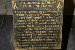 Plaque at the base of the "The Donald J. Trump Enduring Flame" statue.