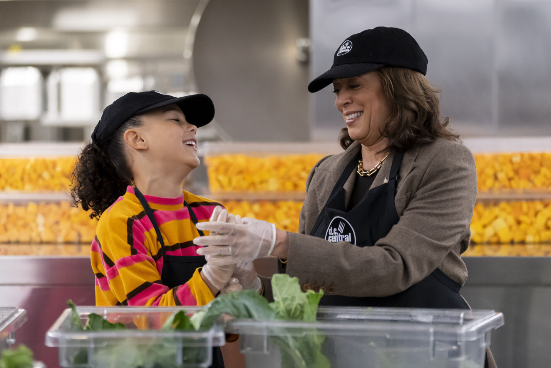 Vice President Kamala Harris, right, and her grand-niece Leela Ajagu, left, celebrate Thanksgiving Day by helping to prepare vegetables at the DC Central Kitchen in Washington Thursday, Nov. 28, 2024. (AP Photo/Ben Curtis)