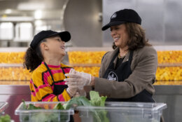 Vice President Kamala Harris, right, and her grand-niece Leela Ajagu, left, celebrate Thanksgiving Day by helping to prepare vegetables at the DC Central Kitchen in Washington Thursday, Nov. 28, 2024. (AP Photo/Ben Curtis)