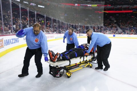 NHL referee Mitch Dunning taken off ice on stretcher after violent collision