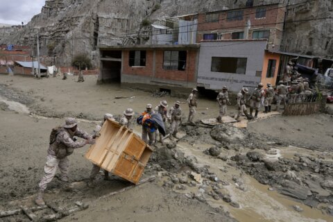 Heavy rains in Bolivia send mud crashing into the capital, leaving 1 missing and destroying homes