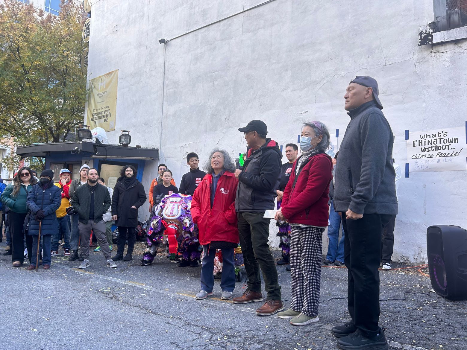 People standing at mural unveiling in D.C.'s Chinatown