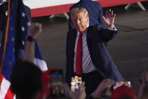 The Latest: Trump and Harris win reliable states while voters await battleground results