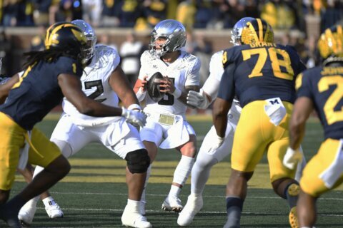 Dillon Gabriel throws a TD pass and runs for a score to lead No. 1 Oregon to 38-17 win over Michigan