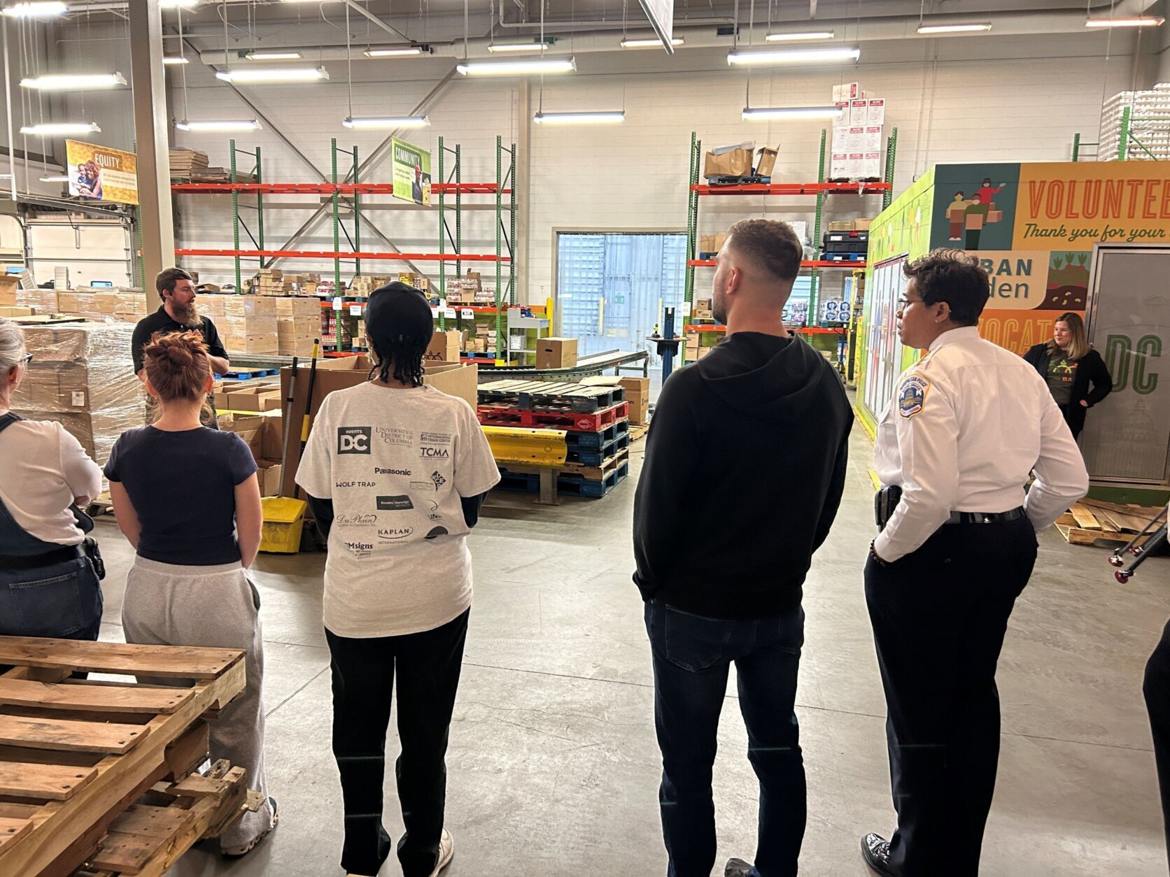 Volunteers in a warehouse putting food into boxes