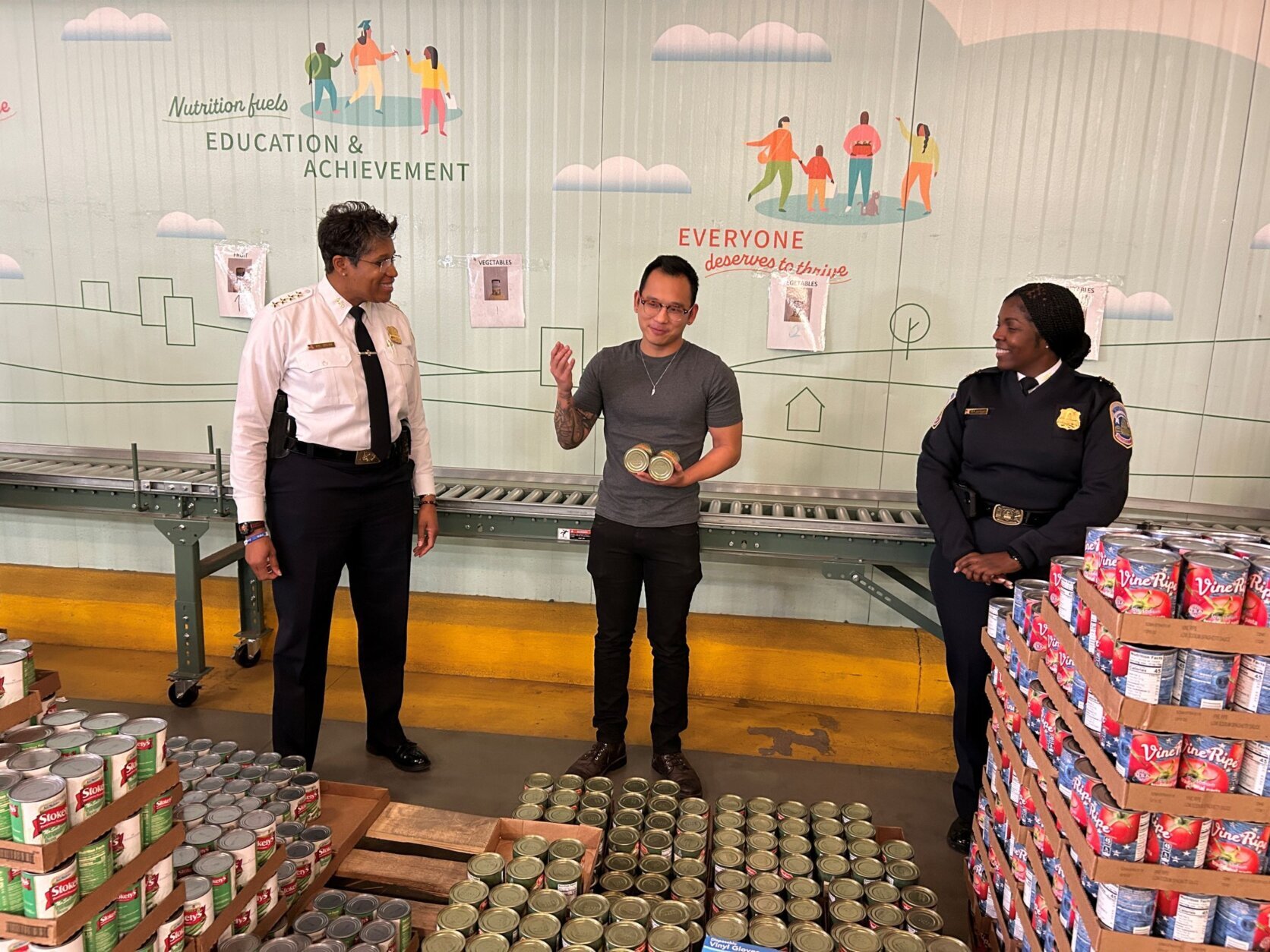 Volunteers in a warehouse putting food into boxes