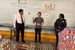 Volunteers in a warehouse putting food into boxes