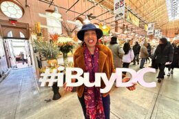 woman holding 'i buy DC' sign