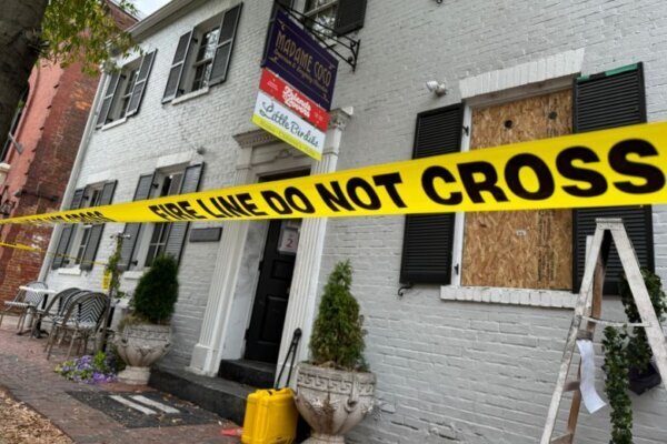 the businesses are taped off by a banner that reads 'do not cross' 