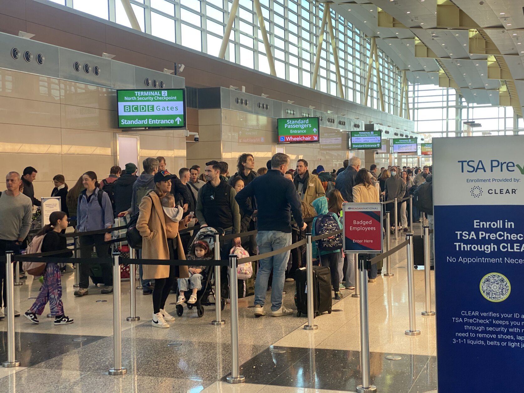 dozens of travelers wait in line at Reagan Airport